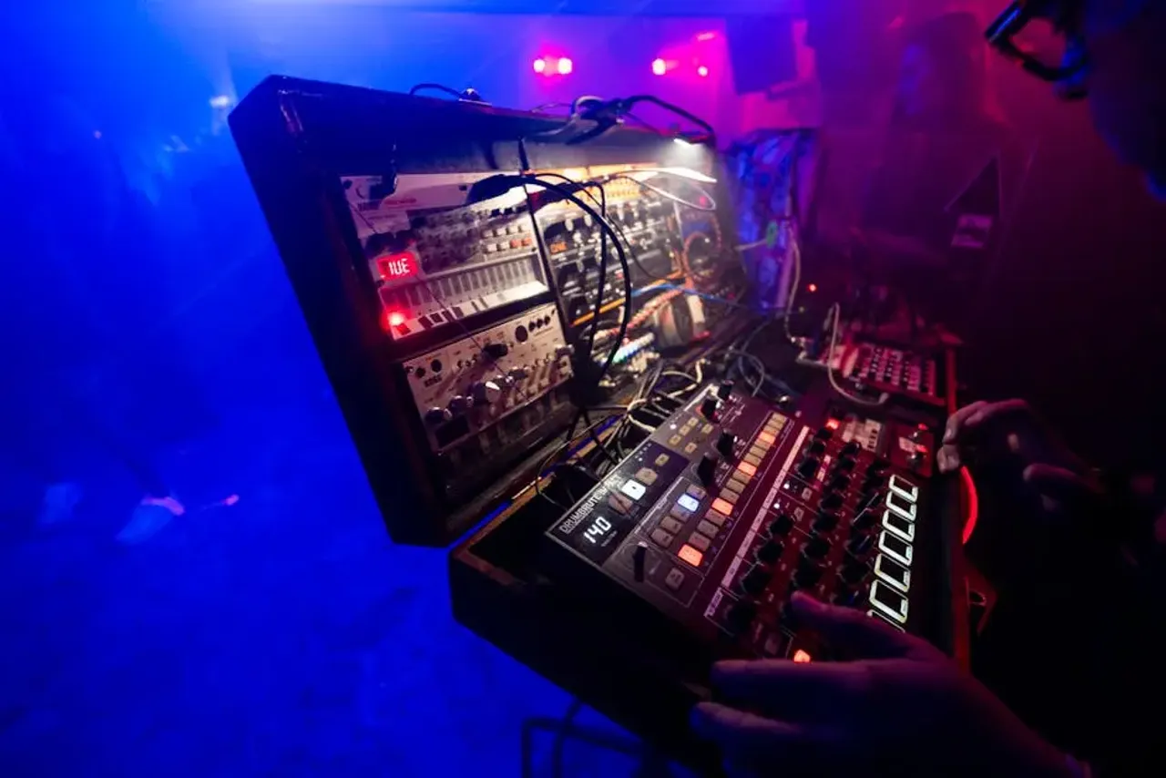 DJ Playing on Console in a Club