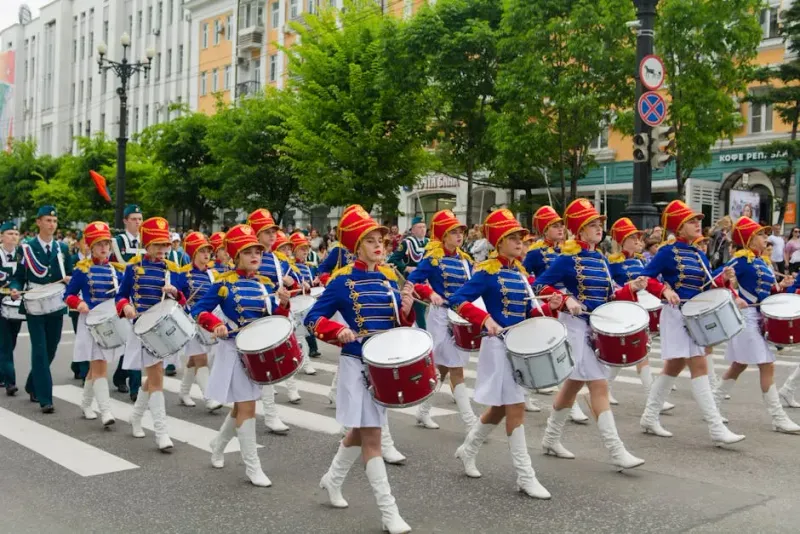 People in Blue and White Uniform Playing Drums