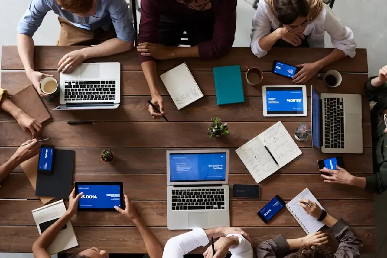 Top View Photo Of People Near Wooden Table