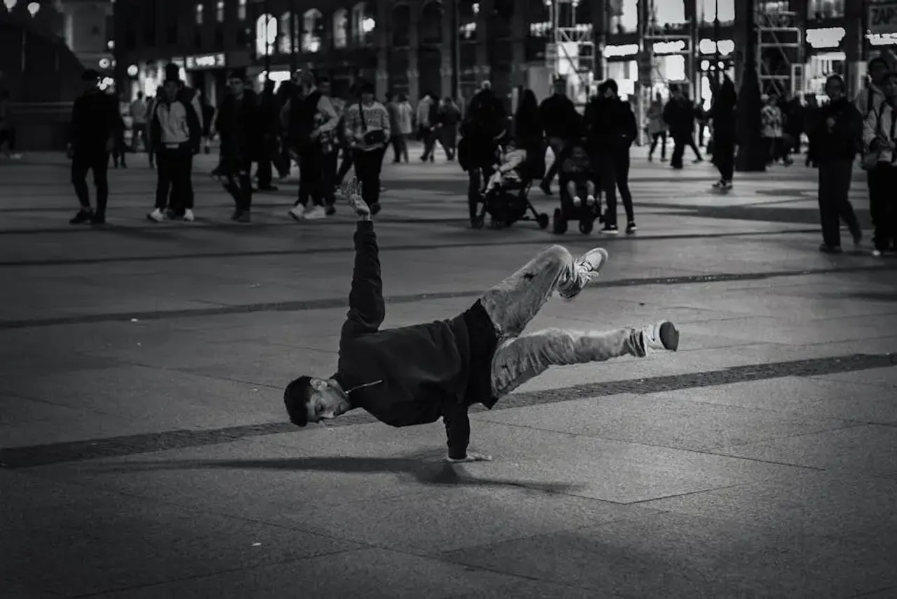 A man doing a handstand in the middle of a city